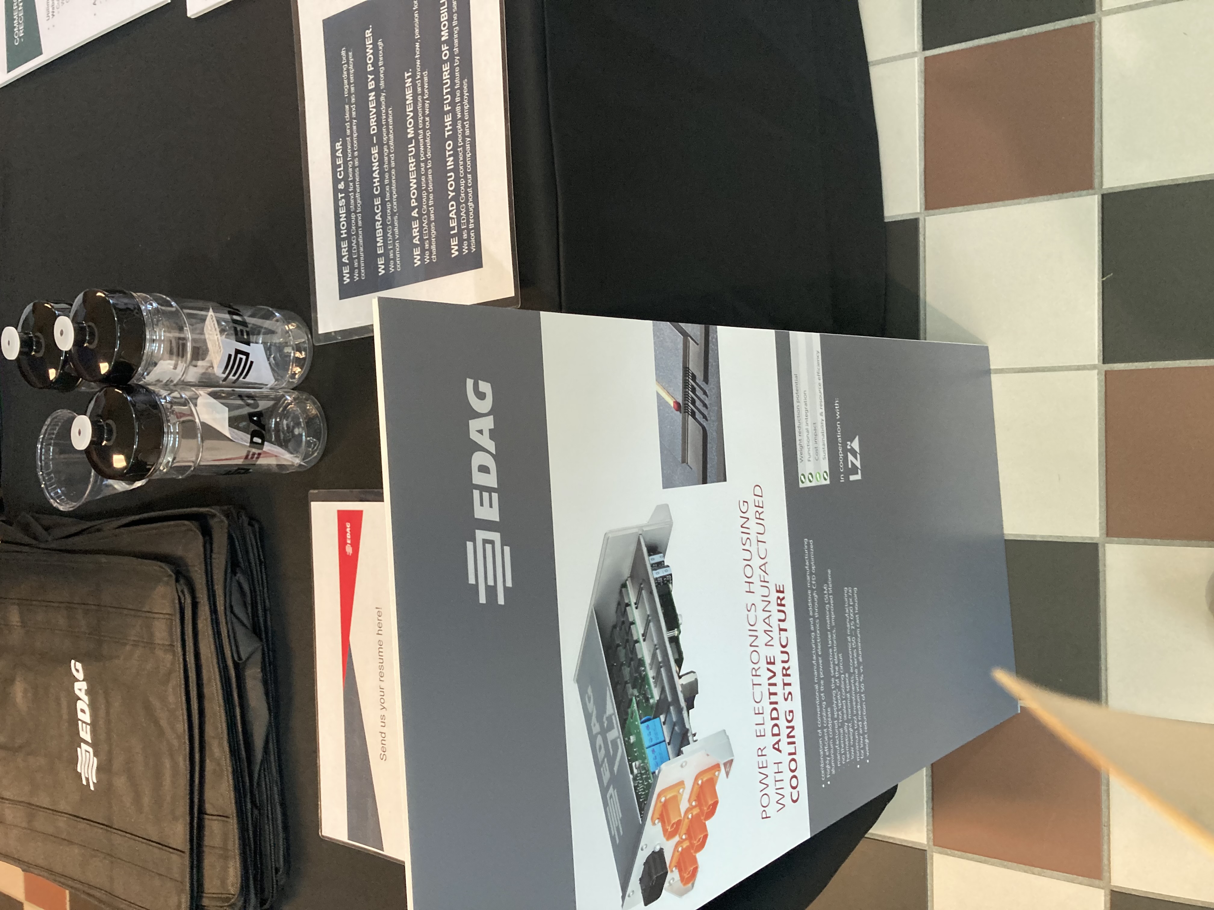 Picture of EDAG table with a poster talking about power electronics housing