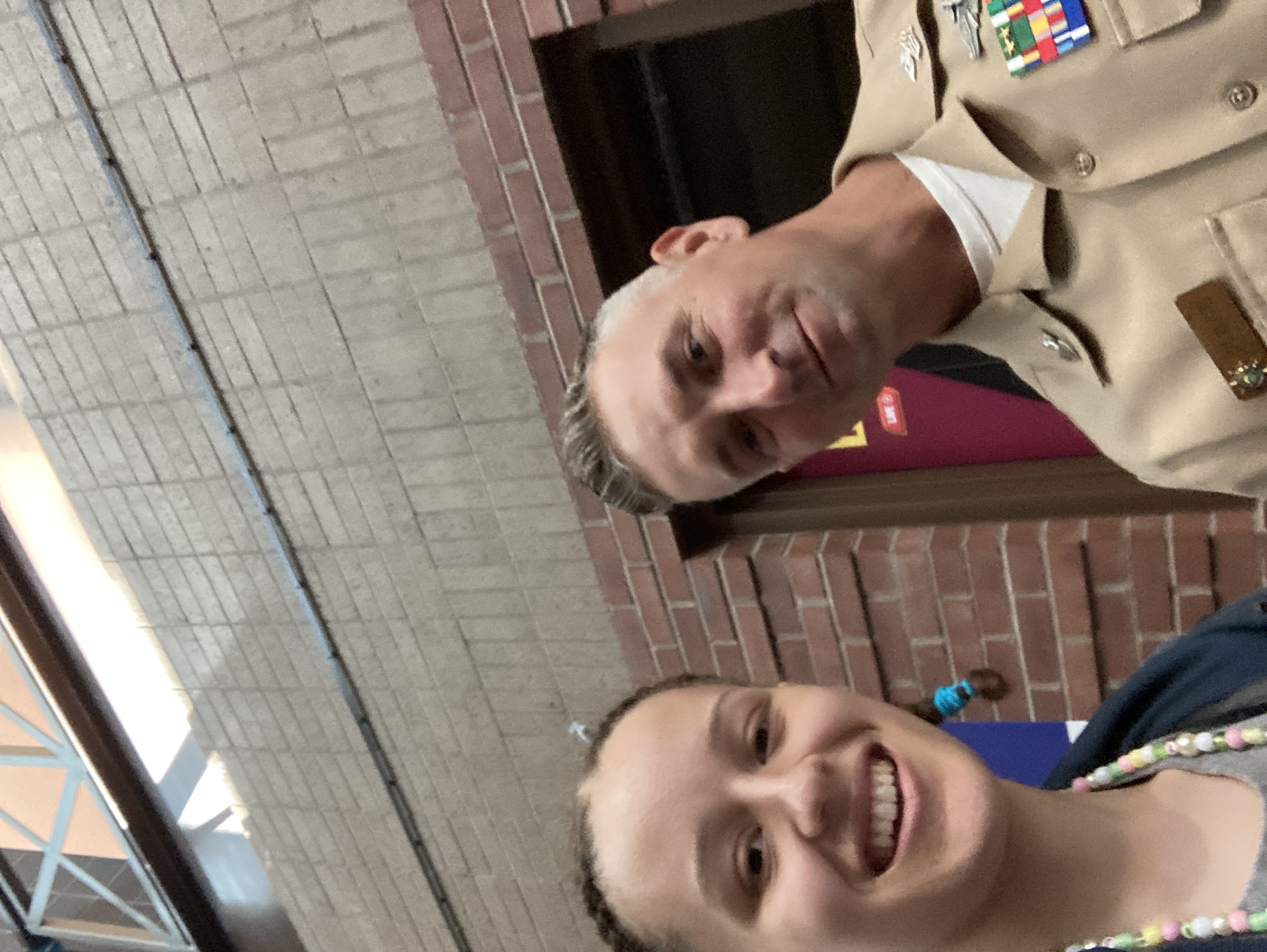 Selfie of Gabrielle with a man wearing a United States Navy uniform